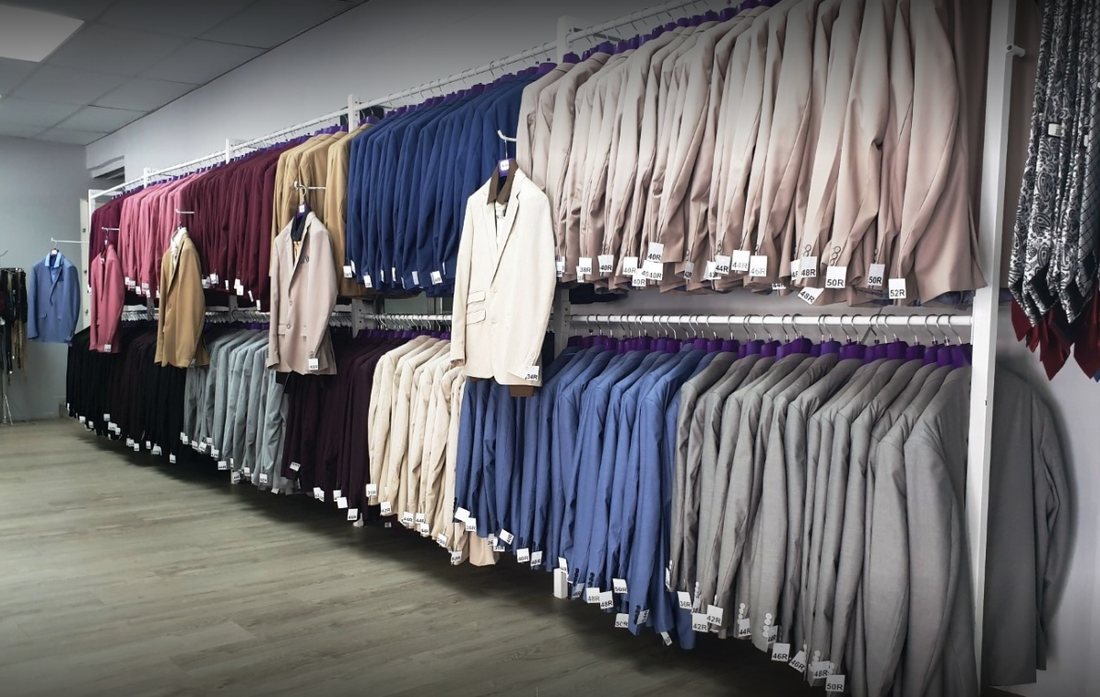Rails of hire suits inside the Suit Hire Paarl shop in Bertville, Paarl
