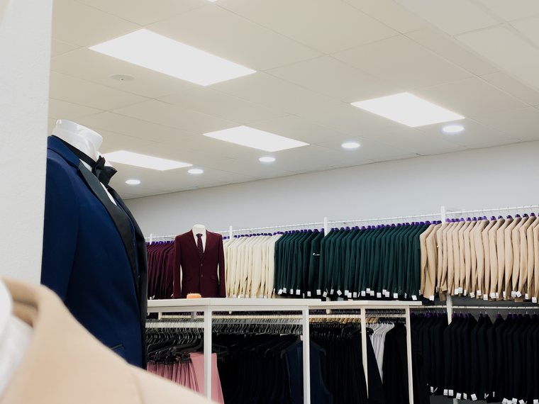 Rail of hire suits in a range of colours at Suit Hire Paarl